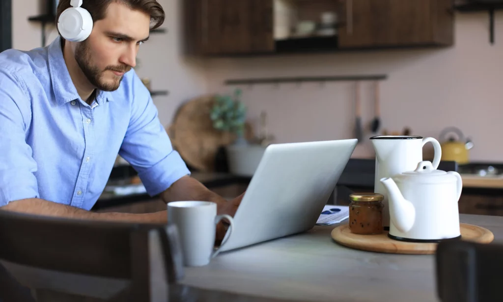 ready for permanent remote workforce a male remote staff working at the dining table of his home