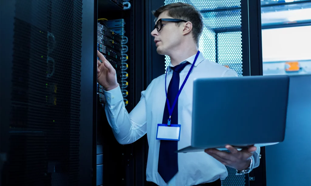 proactive cybersecurity mindset a male cybersecurity engineer checking the physical servers for weaknesses