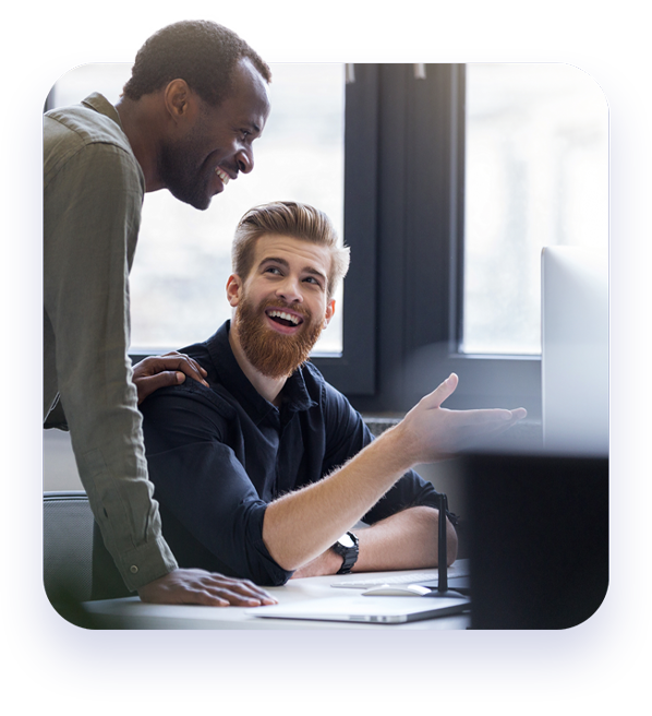 proven audit and assurance process - two male accountants having a happy discussion while looking at computer monitor