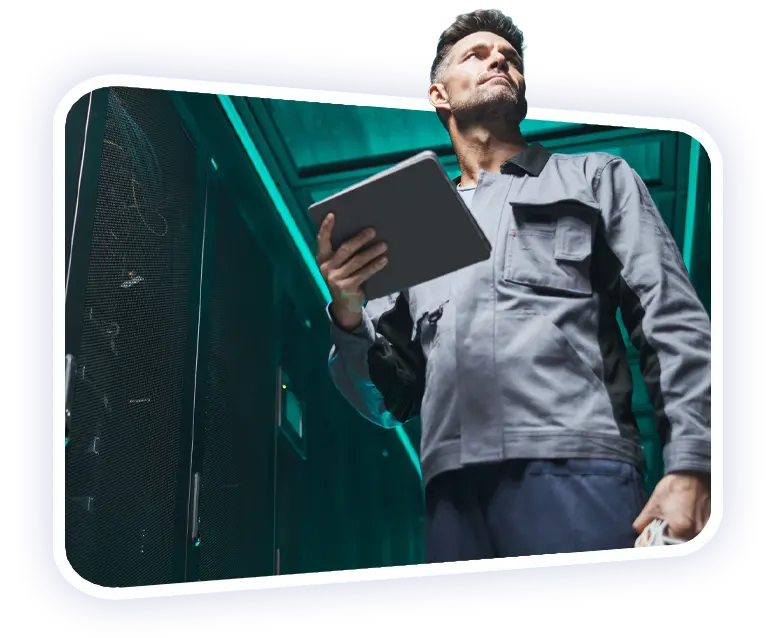 Disruptive Outsourcing Solutions a male IT engineer holding a tablet whilst monitoring their servers' performance